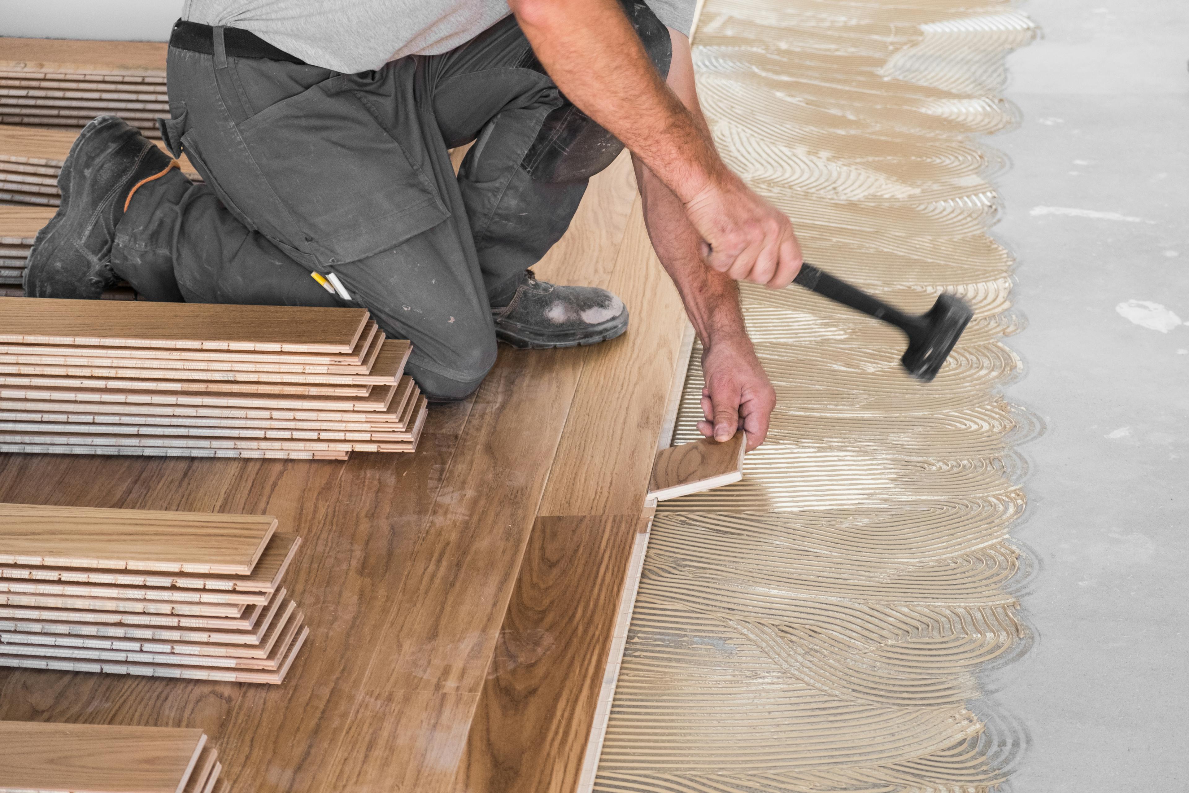 Stock image of someone laying flooring