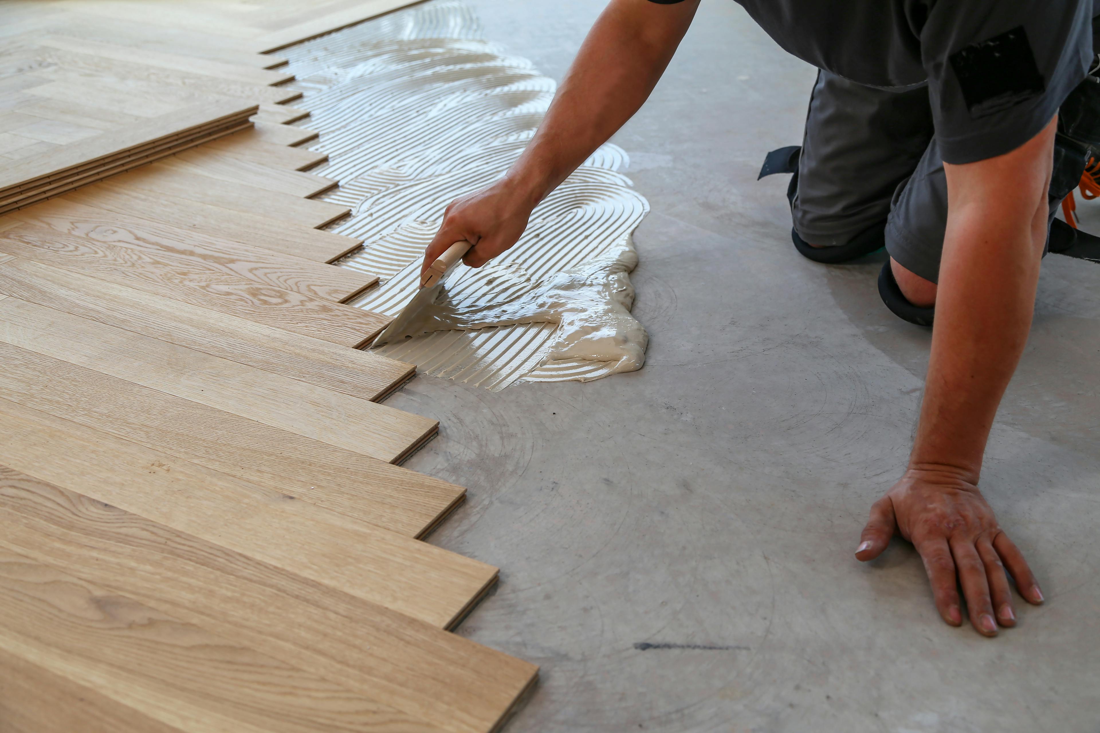 Stock image of someone laying wood floor